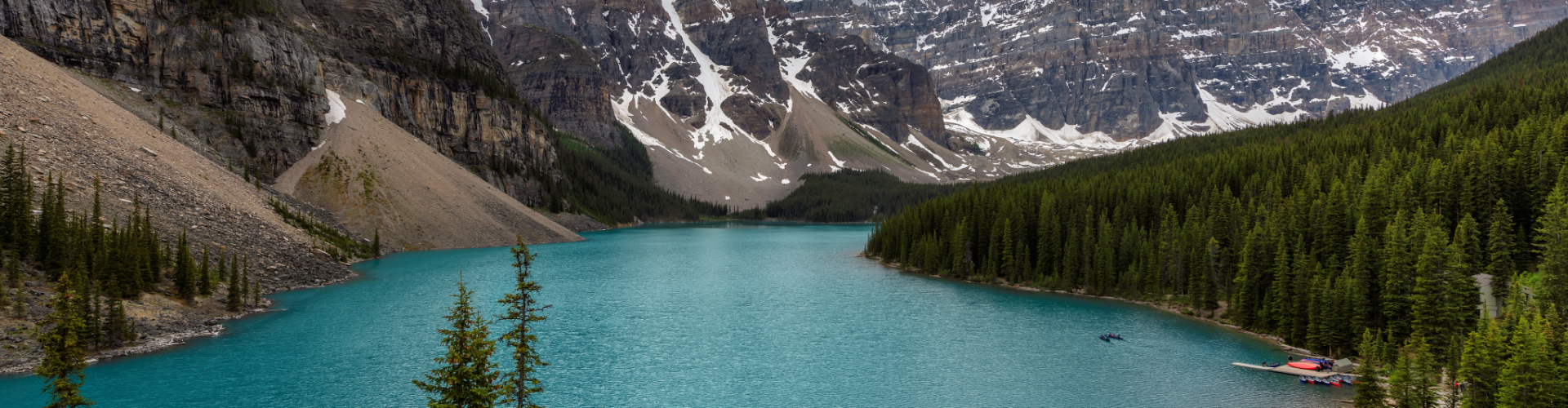 Banff, Alberta: Water surrounded by trees and mountains.