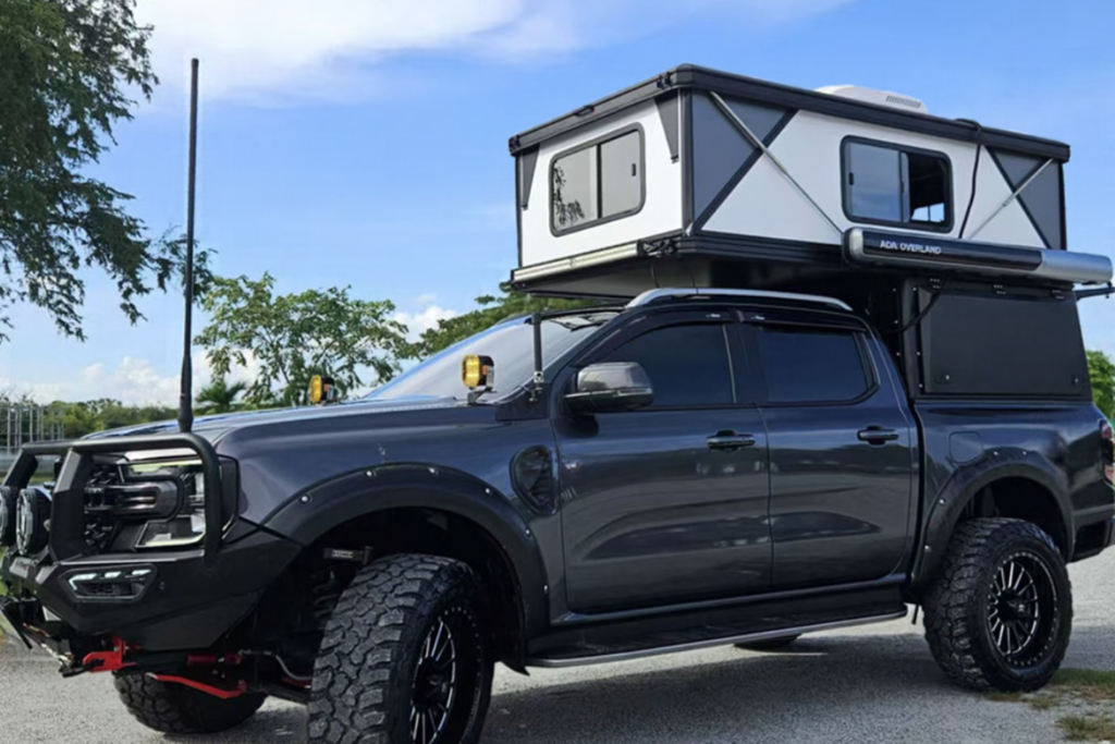 A hard shell camper on the back of a truck