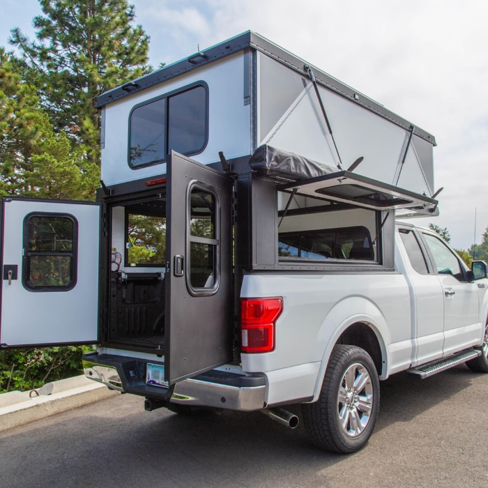 The back of a pop-up camper with the door open