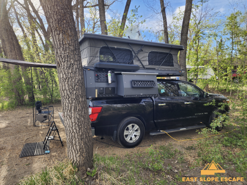 side view of a pop-up camper on a truck.